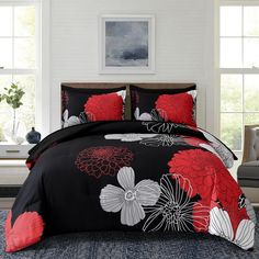 a black and red comforter set with flowers on it