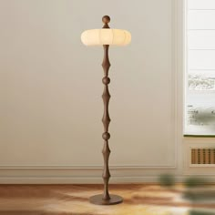 a floor lamp in the corner of a room