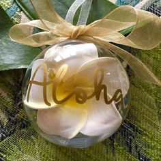 a glass ornament with the word alohe on it