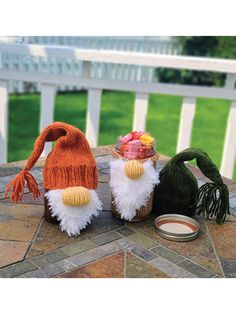 two knitted gnomes sitting next to each other