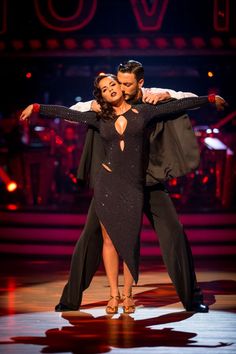 a man and woman dancing on stage