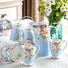 a table topped with blue vases filled with flowers