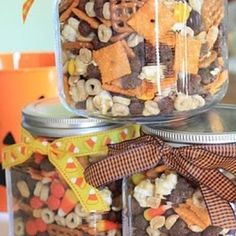 three glass jars filled with different types of snacks