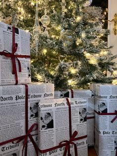 several wrapped presents sitting in front of a christmas tree