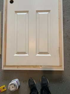 a pair of shoes sitting on top of a door frame next to some construction supplies