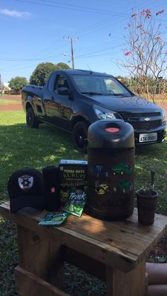 a black truck parked next to a picnic table