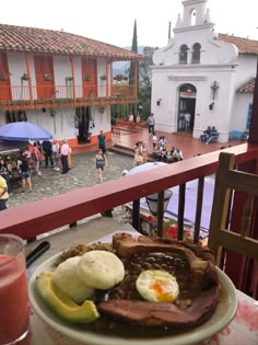 a plate full of food sitting on top of a table next to a glass of juice