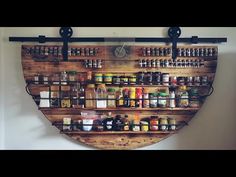 a wall mounted spice rack with bottles on it