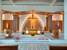 the inside of a church with wooden pews and decorations on it's walls