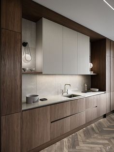 a kitchen with wooden cabinets and white counter tops next to a herringbone flooring