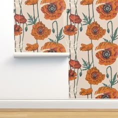 an orange flowered wallpaper is next to a white wall with a wooden floor