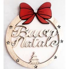 a wooden sign that says bacon natale with a red bow