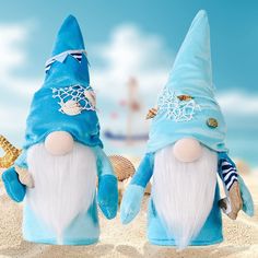 two blue and white gnomes are in the sand