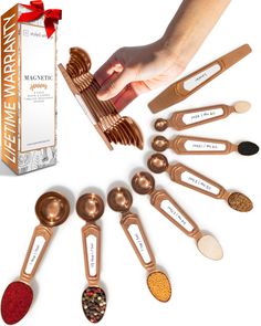 a hand reaching for spoons in front of a box