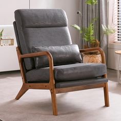 a gray reclining chair in a living room with a potted plant on the side