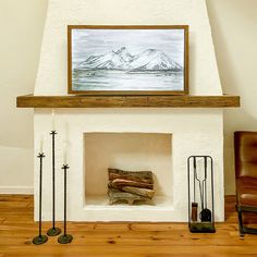 a fireplace with a painting on the mantle