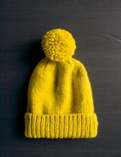 a yellow knitted hat on a black background