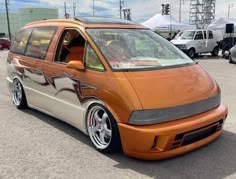 an orange van parked in a parking lot