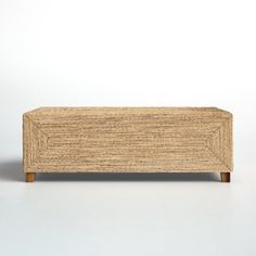 a small wooden box sitting on top of a white table next to a planter