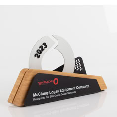 a black and white business card holder with a logo on the front that reads mcchune - loggan equipment company