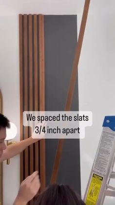 DIY Affordable Wood Slat Accent Wall || Cost Breakdown: Sanded Plywood - $25, Stain - $7 Room Divider Slat Wall, How To Make Slat Wall, Wood Slat Front Porch, Fake Wood Wall Paneling, Slat Wall With Tv Mount, Slat Wall To Ceiling, Slat Wall Ceiling Ideas, Diy Wood Slats Wall, Diy Vertical Wood Slat Wall