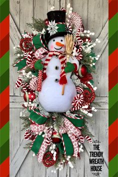 a christmas wreath with a snowman and candy canes