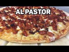 a large pizza sitting on top of a pan covered in cheese and bacon toppings