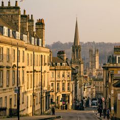 an old city street with people walking on it