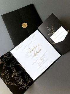 an open black and gold wedding card