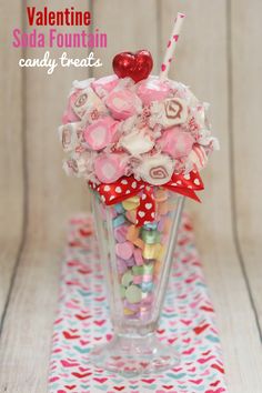 valentine's day candy bouquet in a glass vase on a table with red and white polka dots