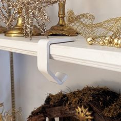 there is a shelf with gold ornaments on it and other decorations in the corner next to it