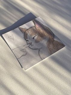 a drawing of a cat with a heart on it's forehead and eyes closed