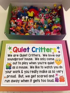 a box filled with lots of different colored stuffed animals next to a sign that says quiet critters