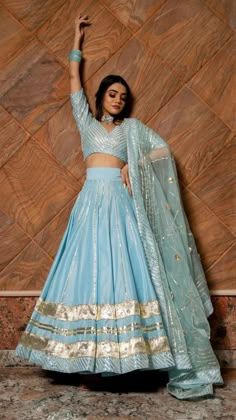 Sky Blue Lehenga Set with Gota Pati work Featuring an Sky Blue Lehenga Set with Gota Pati work base. It is paired with a matching blouse and a Dupatta This product will be shipped to you after 1-2 weeks from the date of order placed. All custom made orders are not returnable {VARIATION MAY COME DEPENDING UPON AVALIBILITY OF LACES OR GOTTA PATI} NOTE: Visual Samples on website may differ slightly from actual product due to light & effects during photography (Length & Breadth have 1 n 1.5 inches + Sky Blue Lengha, Sky Blue Lehenga, Flared Lehenga, Cotton Silk Fabric, Independance Day, Zari Embroidery, Potli Bag, Ritu Kumar