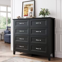 a black dresser in a white living room