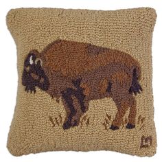 an embroidered bison pillow is shown on a white background with brown and tan accents,