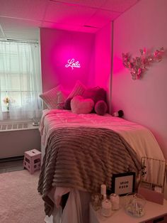 a bed with pink lights in a bedroom