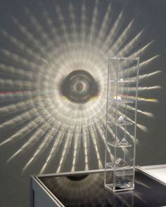 an object is shown in front of a wall with the sun shining through it,