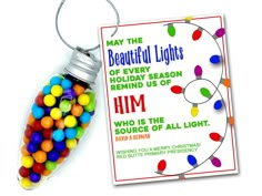 a christmas ornament with candy in it next to a tag that says, may the beautiful lights of every holiday season remind us of him