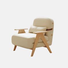 a white leather chair with wooden legs