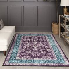 a living room filled with furniture and a purple rug