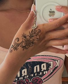 a woman taking a selfie with her cell phone and tattoos on her arm,