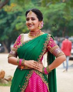 a woman in a green and pink sari