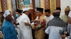 several men in traditional garb talking to each other