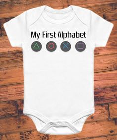 a white baby bodysuit with the words, my first alphabet and four different symbols