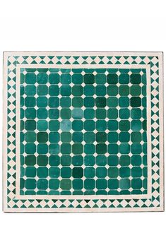 a green and white rug with geometric designs