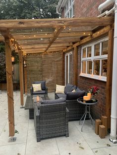 an outdoor living area with furniture and string lights