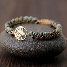 Our Natural African Turquoise Stone Multi Layer Handmade Bracelet is more than just a beautiful accessory - it also offers healing benefits. Made with natural African Turquoise, this bracelet is believed to bring balance, protection, and grounding energy to the wearer. The double rows of 4mm round beads and the Tree of Life charm add a touch of boho-chic spirituality to your style. Handmade with care and attention to detail, this adjustable bracelet is perfect for those seeking balance and self-expression. Whether you wear it for its healing properties or its unique and ethnic-inspired style, this bracelet is a versatile and beautiful addition to any wardrobe. African Turquoise Bracelet, Wrap Armband, Boho Style Bracelets, Beaded Leather Wraps, Tree Of Life Bracelet, Jasper Bracelet, Personalized Bracelet, Stone Wrapping, Natural Stone Bracelets