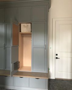 an empty room with gray cabinets and drawers