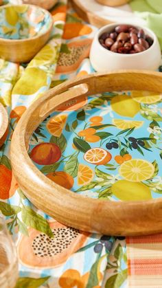 two wooden trays sitting on top of a colorful table cloth